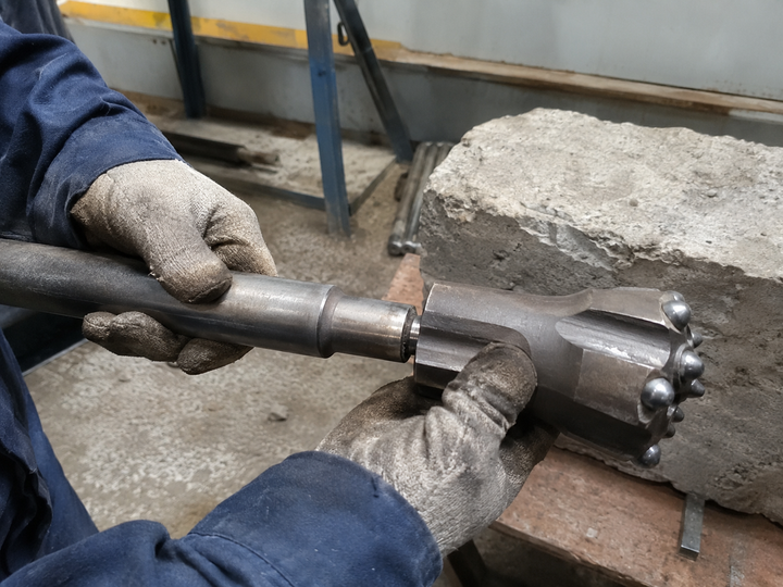 Tapered button bit assembled with an H22 drill rod for bit and rod compatibility checks
