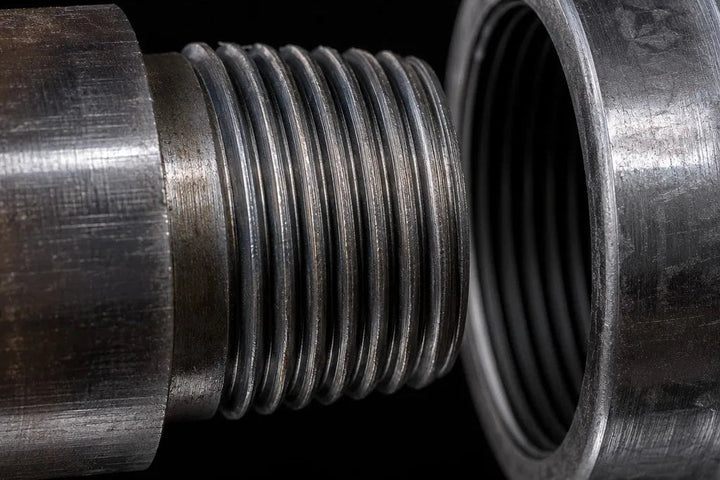 Close-up of a T38 rope thread on a top-hammer extension rod used to illustrate T38 vs T45 drill-string compatibility