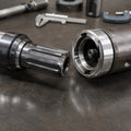 DTH drill bit shank positioned beside a matching hammer chuck for compatibility inspection