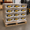 Y19A rock drill export packaging — compact drill bodies in cardboard boxes on pallet, stretch-wrapped for container