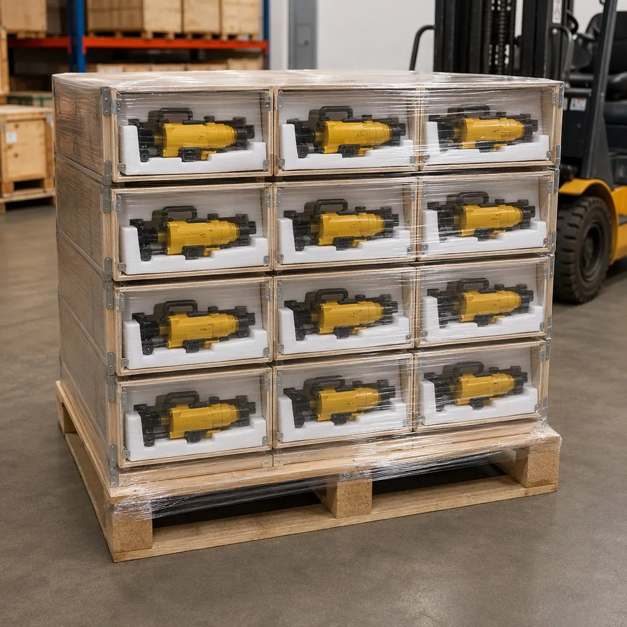 Y19A rock drill export packaging — compact drill bodies in cardboard boxes on pallet, stretch-wrapped for container