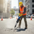 PerfoMax OP-3 pneumatic pick breaker in use on concrete road surface at a work site